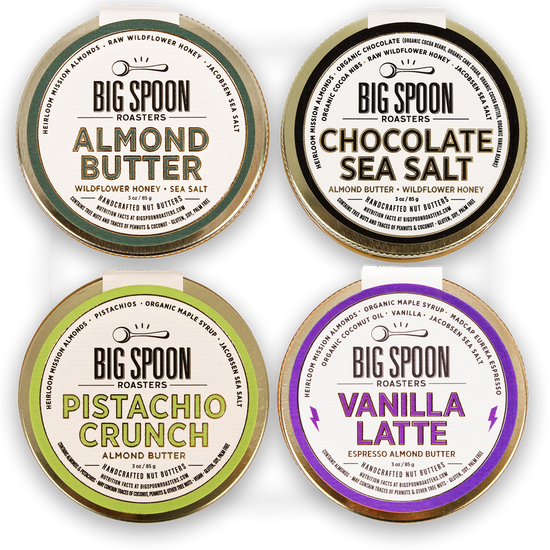 Four containers of Big Spoon Roasters almond butter with different flavors on a white background.