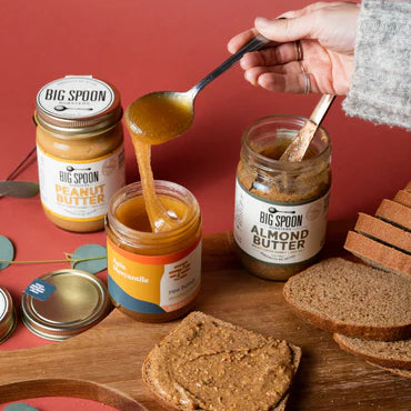 Picture of hand spooning honey from a jar