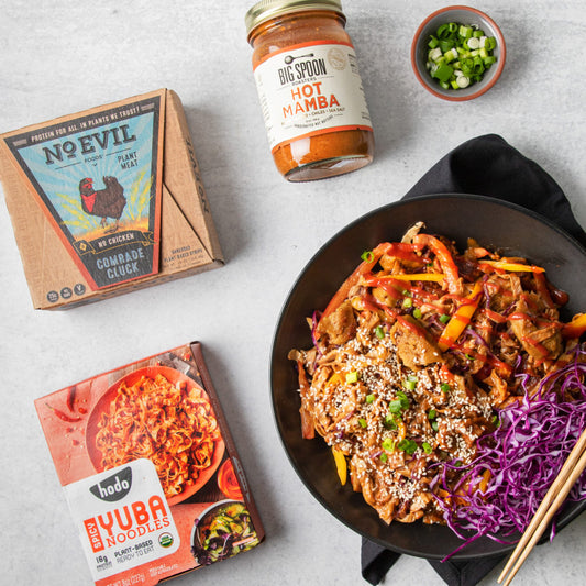 colorful thai noodle dish with boxes of ingredients