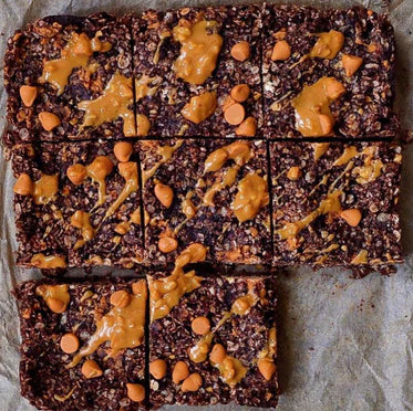 homemade chocolate bars with orange ginger peanut butter topping