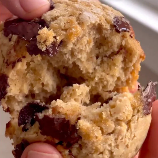 A person pulls apart a Nut Butter & Banana Muffin