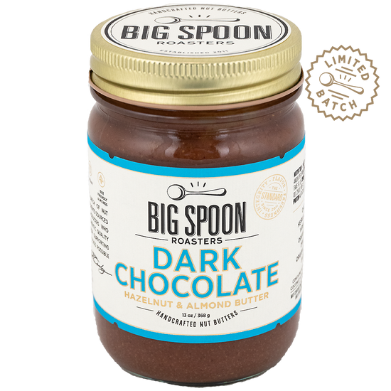 Jar of Big Spoon Roasters Dark Chocolate Hazelnut & Almond Butter with a gold lid on a white background.