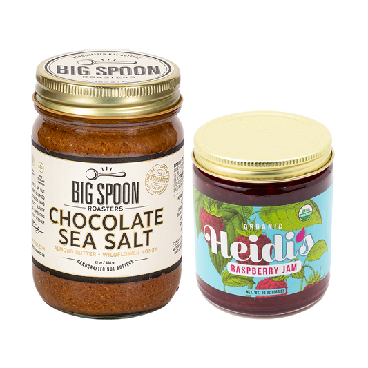 a jar of Chocolate Sea Salt almond butter next to a jar of Heidi's Raspberry Jam