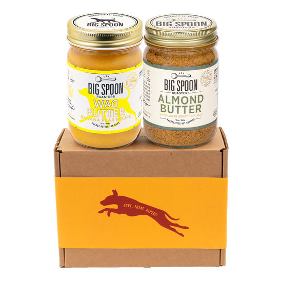 Two jars of Big Spoon Roasters nut butter - Banana Flax Wag Butter and Almond Butter with Wildflower Honey on a branded box 