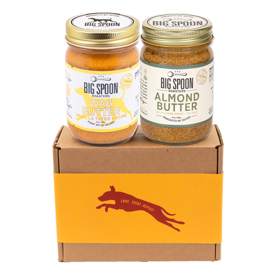 Jar of Vanilla Tater Wag Butter and a jar of Almond Butter with Wildflower Honey on top of a gift box