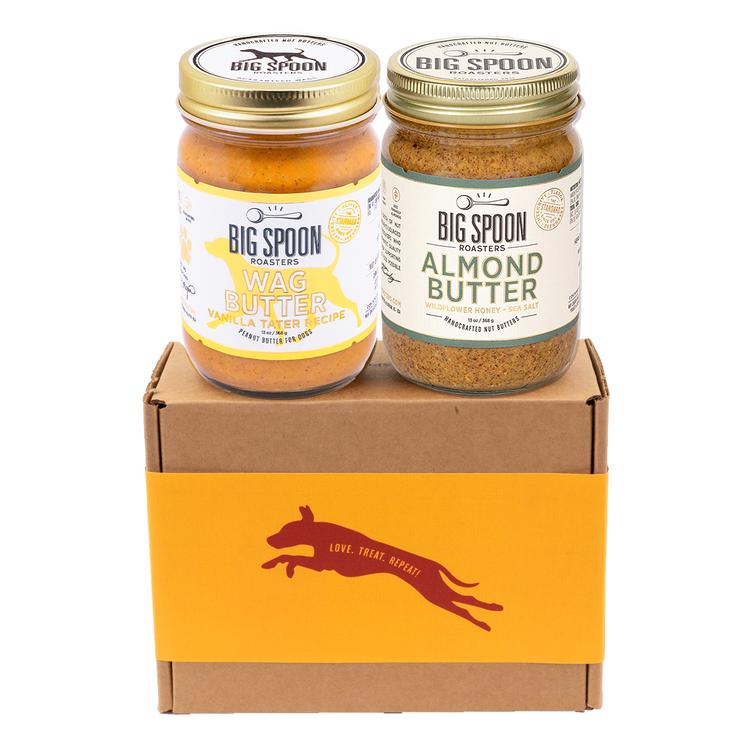 Jar of Vanilla Tater Wag Butter and a jar of Almond Butter with Wildflower Honey on top of a gift box