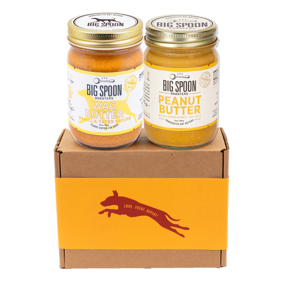 Jar of Vanilla Tater Wag Butter and a jar of Peanut Butter with Wildflower Honey on top of a gift box