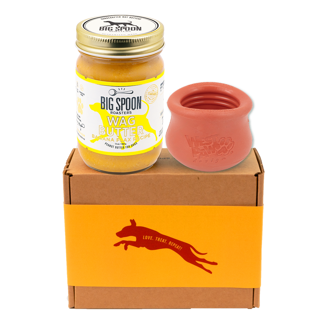 Jar of 'Big Spoon Roasters' Wag Butter with an red west paw toppl on a branded box.