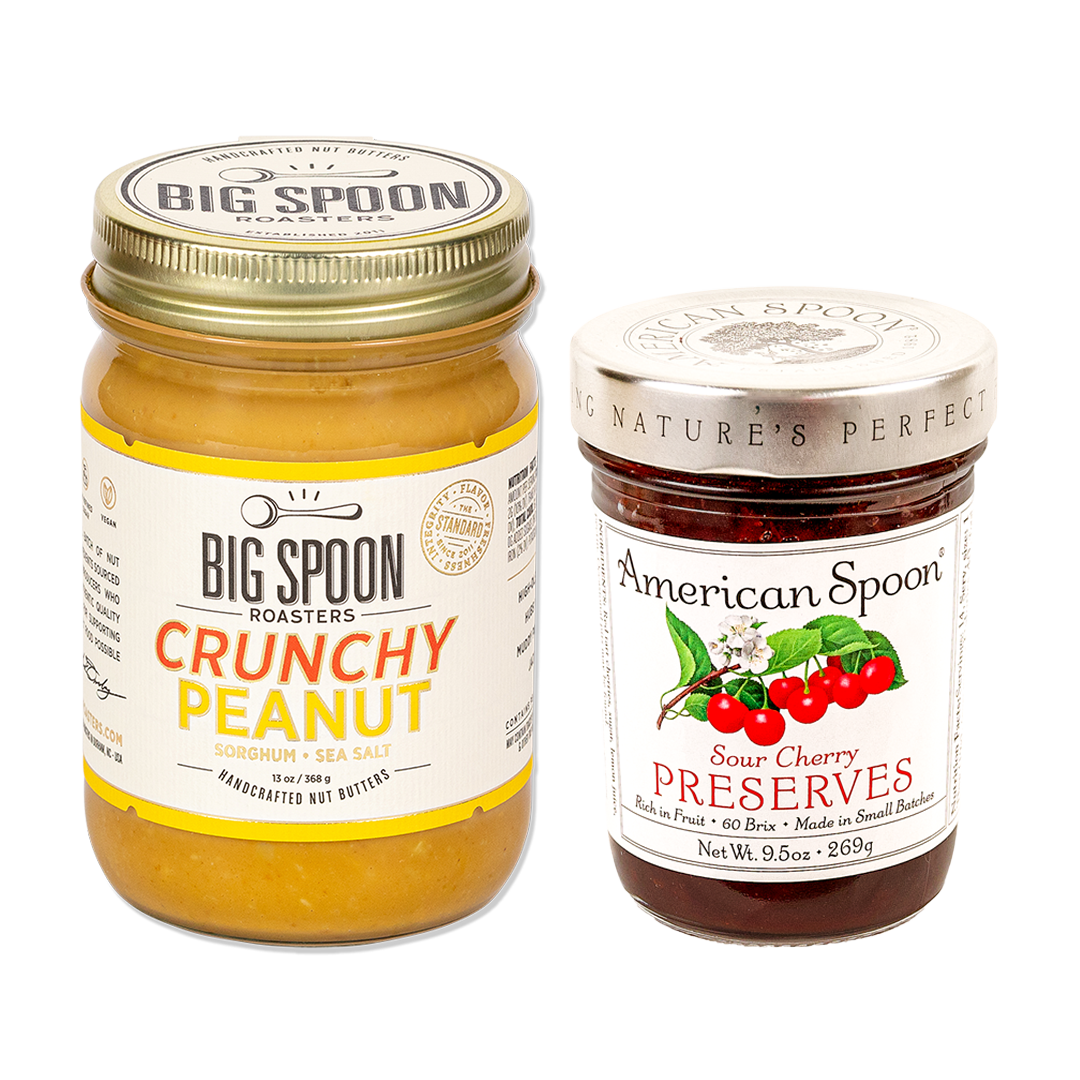 One jar of peanut butter from Big Spoon Roasters and one jar of sour cherry preserves from American Spoon on white background