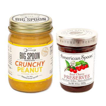 One jar of peanut butter from Big Spoon Roasters and one jar of sour cherry preserves from American Spoon on white background