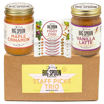 Big Spoon Roasters staff picks trio with jars of maple cinnamon, figgy chai bars, and vanilla latte on a cardboard box.