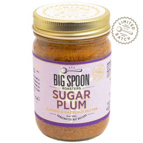 Jar of Big Spoon Roasters Sugar Plum almond and hazelnut butter with a gold lid on a white background.