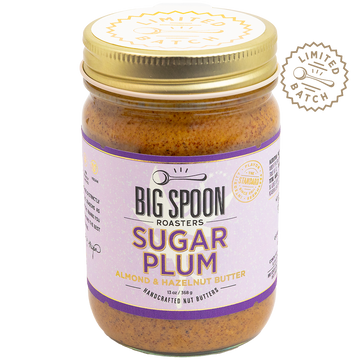 Jar of Big Spoon Roasters Sugar Plum almond and hazelnut butter with a gold lid on a white background.
