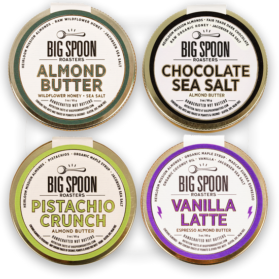 Four containers of Big Spoon Roasters almond butter with different flavors on a white background.