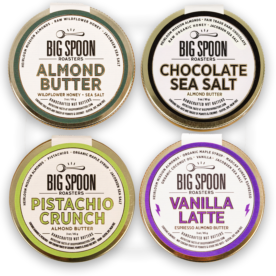 Four containers of Big Spoon Roasters almond butter with different flavors on a white background.