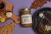 Jar of Big Spoon Roasters Chai Spice peanut and almond butter on a purple background with ingredients around it.