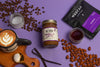 Vanilla latte jar, coffee beans, and coffee packaging on a purple background