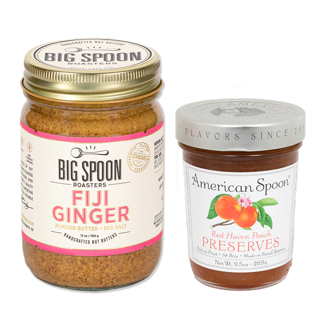 13 ounce jar of Big Spoon Roasters Fiji Ginger Almond butter inside a glass jar with golden lid. 9.5 ounce jar of American Spoon Red Haven Peach Preserves in a glass jar with silver lid.