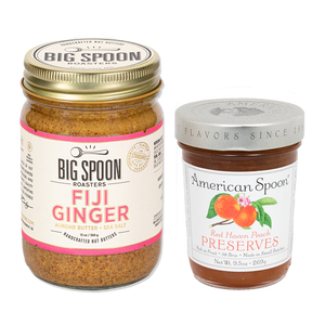 13 ounce jar of Big Spoon Roasters Fiji Ginger Almond butter inside a glass jar with golden lid. 9.5 ounce jar of American Spoon Red Haven Peach Preserves in a glass jar with silver lid.