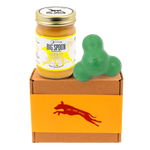 Jar of 'Big Spoon Roasters' Wag Butter on a box with a green West Paw Tux toy.