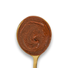  Dark Chocolate Hazelnut & Almond Butter swirled on a golden spoon. 