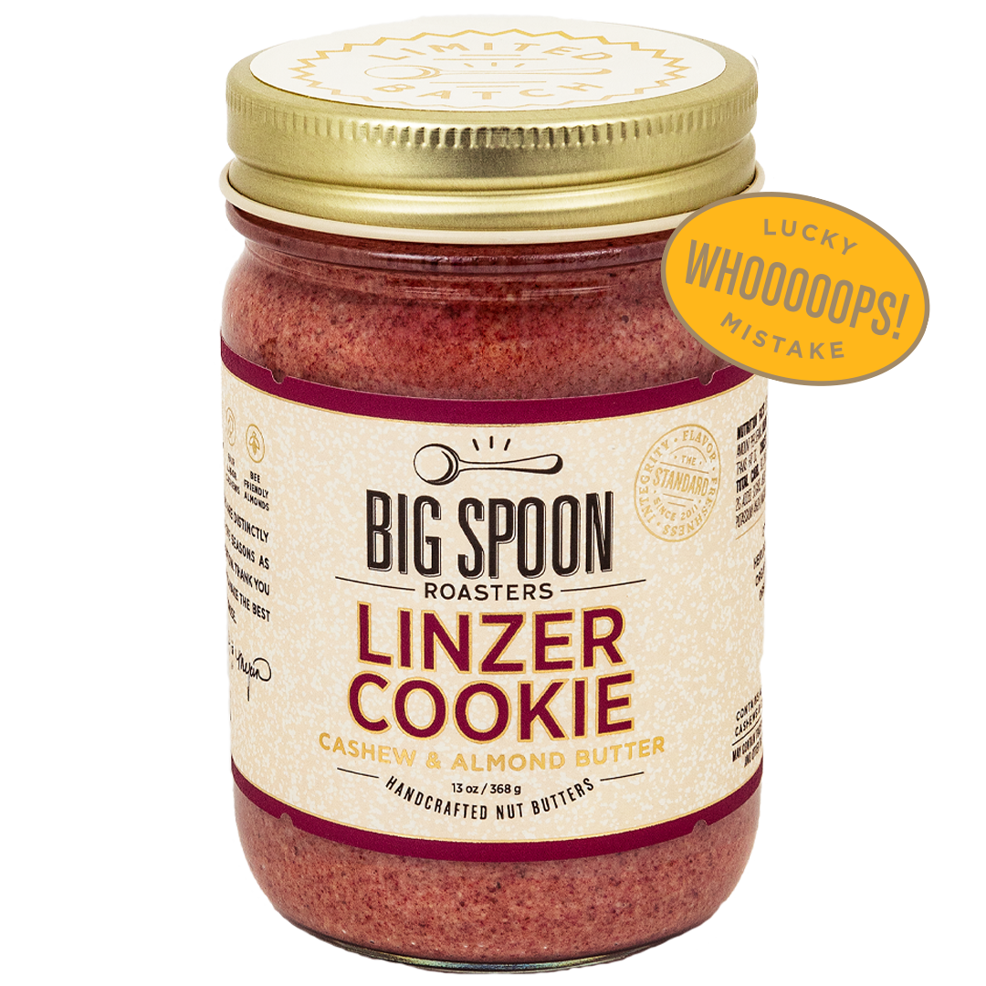 Jar of Big Spoon Roasters Linzer Cookie cashew and almond butter wth a badge overlaid that says LUCKY WHOOPS MISTAKE