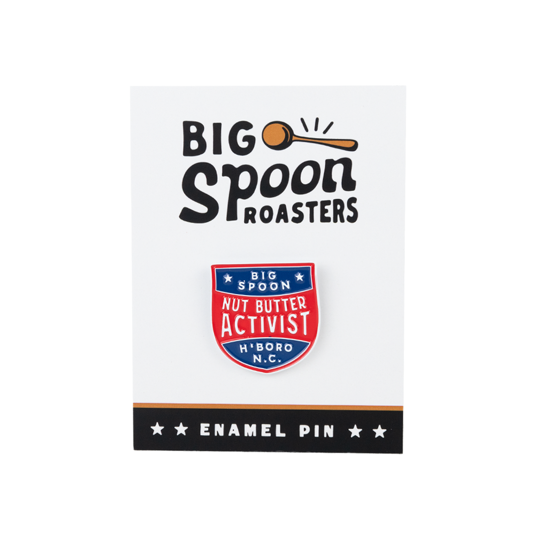 red, blue, and white enamel pin on a backing reading BIG SPOON ROASTERS ENAMEL PIN