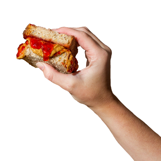 hand holding PB&J sandwich